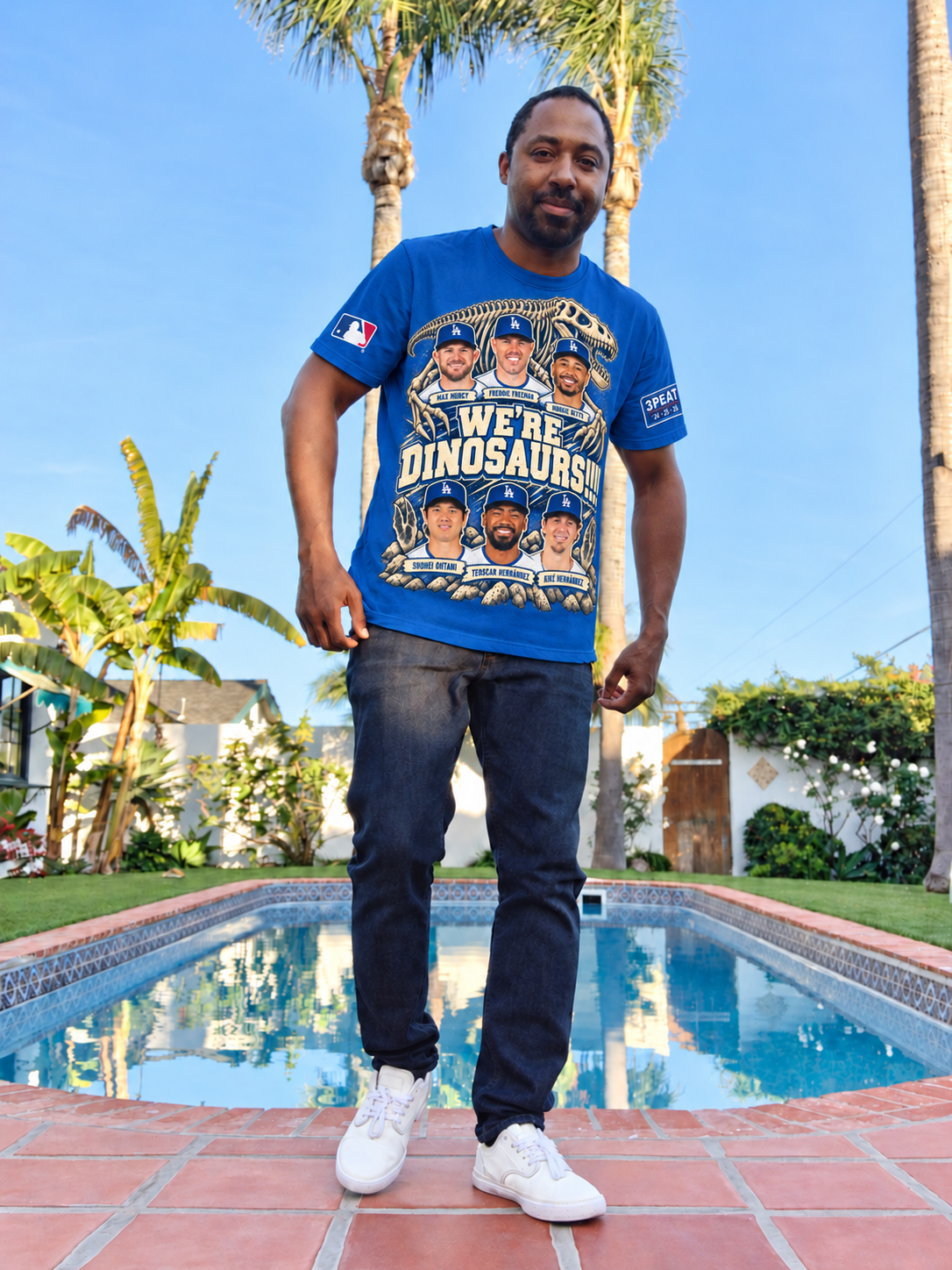 Gregory beside a pool, modeling the Dodger Blue We’re Dinosaurs six-player shirt in a photo-based clothing mockup